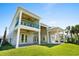 Expansive back porch features a covered patio, outdoor fans, and lush green lawn at 985 Shipmaster Ave., Myrtle Beach, SC 29579