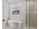 Clean bathroom featuring a freestanding tub, shower, and bright natural light at 985 Shipmaster Ave., Myrtle Beach, SC 29579