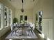 This dining room features lots of natural light, modern light fixture and seating for 8 at 985 Shipmaster Ave., Myrtle Beach, SC 29579