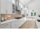 Bright kitchen boasts white cabinetry, stainless steel appliances, and stylish backsplash with access to outdoor space at 985 Shipmaster Ave., Myrtle Beach, SC 29579