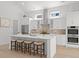 Bright kitchen featuring white cabinets, a central island with seating, stainless steel appliances and natural light at 985 Shipmaster Ave., Myrtle Beach, SC 29579