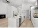 Open-concept living space with fireplace, staircase, and kitchen island featuring marble countertops and stainless steel dishwasher at 985 Shipmaster Ave., Myrtle Beach, SC 29579