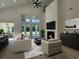 Comfortable living room featuring large windows, modern furniture, and a cozy fireplace at 985 Shipmaster Ave., Myrtle Beach, SC 29579