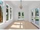 Sunlit room with large windows and doors that offer scenic backyard views at 985 Shipmaster Ave., Myrtle Beach, SC 29579