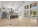 Open floor plan with kitchen island, patio doors and bright lighting creates an inviting atmosphere at 985 Shipmaster Ave., Myrtle Beach, SC 29579