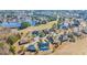 Aerial view of a neighborhood featuring large houses, ponds, and lush greenery at 1004 Whooping Crane Dr., Conway, SC 29526
