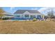 Expansive backyard with a pool, patio area, and lush green lawn, perfect for outdoor activities at 1004 Whooping Crane Dr., Conway, SC 29526