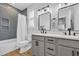Updated bathroom with tile shower, gray vanity with dual sinks, and modern lighting at 1004 Whooping Crane Dr., Conway, SC 29526