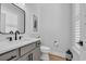 Powder room with black framed mirror, gray vanity, and decorative accents at 1004 Whooping Crane Dr., Conway, SC 29526