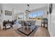 Bright dining room with large windows, a modern chandelier, and hardwood floors at 1004 Whooping Crane Dr., Conway, SC 29526