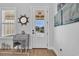Charming entryway featuring a rolltop desk, nautical decor, and a view of the front yard through a glass paneled door at 1004 Whooping Crane Dr., Conway, SC 29526