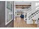 Inviting foyer with wood floors, white staircase, and an open view into the living room with wood beam ceiling at 1004 Whooping Crane Dr., Conway, SC 29526