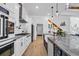 Modern kitchen boasts stainless appliances, farmhouse sink, marble counters, and white cabinets at 1004 Whooping Crane Dr., Conway, SC 29526