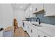 Laundry room with white cabinets, blue backsplash, washer and dryer at 1004 Whooping Crane Dr., Conway, SC 29526