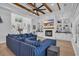 Spacious living room with a fireplace, built-in shelves, wood beam ceiling, and a comfortable blue striped sofa at 1004 Whooping Crane Dr., Conway, SC 29526