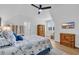 Bright main bedroom featuring a beach-themed decor, ceiling fan, and wooden furniture accents at 1004 Whooping Crane Dr., Conway, SC 29526