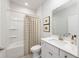 Clean bathroom with a shower-tub combo, white vanity, and neutral-toned shower curtain at 1005 Laconic Dr., Myrtle Beach, SC 29588
