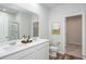 Modern bathroom featuring a double sink vanity, large mirror, and glass enclosed shower at 1005 Laconic Dr., Myrtle Beach, SC 29588