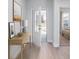 Bright foyer with wood floors, a console table, and an open doorway leading to a bedroom at 1005 Laconic Dr., Myrtle Beach, SC 29588