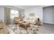 Bright living room featuring a cozy sofa, tufted armchair, and large area rug at 1005 Laconic Dr., Myrtle Beach, SC 29588