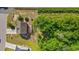 Overhead view of a cozy home with a deck nestled among lush greenery and adjacent to a quiet road at 101 Winding Path Dr., Loris, SC 29569