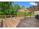 Large wooden deck with pergola and wooden railing overlooks private backyard at 101 Winding Path Dr., Loris, SC 29569