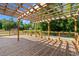 Large wooden deck with pergola and wooden railing overlooks private backyard at 101 Winding Path Dr., Loris, SC 29569
