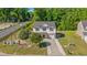 Charming two-story home with attached garage, nicely landscaped front yard, and a paved driveway at 101 Winding Path Dr., Loris, SC 29569