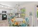Bright eat-in kitchen with white cabinets, stainless appliances, and large window at 101 Winding Path Dr., Loris, SC 29569