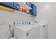 Bright laundry room features front load washer and dryer with overhead storage at 101 Winding Path Dr., Loris, SC 29569