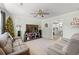 Cozy living room features plush seating, ceiling fan, and seamless flow to an adjacent modern kitchen at 101 Winding Path Dr., Loris, SC 29569
