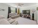 Comfortable living room with plush seating, ceiling fan, large TV, and light green walls at 101 Winding Path Dr., Loris, SC 29569