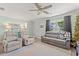 Comfortable living room with plush seating, ceiling fan, large TV, and light green walls at 101 Winding Path Dr., Loris, SC 29569