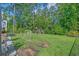 Spacious backyard with lush green grass, mature trees, and a playset and soccer goal at 1011 Maxwell Dr., Little River, SC 29566