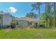 Fenced backyard with lawn, patio, outdoor seating, and mature trees providing shade and privacy at 1011 Maxwell Dr., Little River, SC 29566
