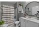 Bathroom featuring a shower-tub combo, modern fixtures, and a stylish vanity with round mirror at 1011 Maxwell Dr., Little River, SC 29566