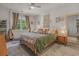 Cozy bedroom with neutral tones, a ceiling fan, and a window with natural light and curtains at 1011 Maxwell Dr., Little River, SC 29566