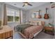 Comfortable bedroom with ceiling fan, natural light, and a relaxing ambiance with guitars on the wall at 1011 Maxwell Dr., Little River, SC 29566