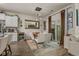 Open dining area with modern light fixture, wine rack, and patio access with brown curtains at 1011 Maxwell Dr., Little River, SC 29566
