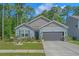 Charming single-Gathering home with a manicured lawn and a two-car garage at 1011 Maxwell Dr., Little River, SC 29566