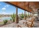 Covered patio boasts stone columns, wood ceiling and outdoor seating overlooking the community pool and manicured landscape at 1011 Maxwell Dr., Little River, SC 29566