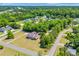 The property features a long driveway and lush surrounding greenery, as seen in this aerial view of the home at 1014 Academy Dr., Conway, SC 29526