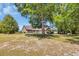 Expansive backyard with mature tree, covered parking, brick home, and ample space for outdoor activities at 1014 Academy Dr., Conway, SC 29526
