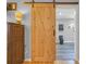 A bathroom features a modern barn door and a toilet at 1014 Academy Dr., Conway, SC 29526