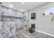 A spa-like bathroom features a frameless glass shower with marble-style tiling and dual shower heads at 1014 Academy Dr., Conway, SC 29526
