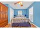 A brightly painted bedroom has hardwood floors, a ceiling fan, and a large wardrobe at 1014 Academy Dr., Conway, SC 29526