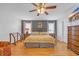 A nicely decorated bedroom features hardwood floors, a ceiling fan, and neutral-colored walls at 1014 Academy Dr., Conway, SC 29526