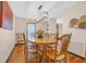 Open dining room with wooden table, chairs, light fixture and wood floors at 1014 Academy Dr., Conway, SC 29526