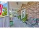 Inviting front porch with comfortable seating, decorative plants, and an arched doorway for a charming entrance at 1014 Academy Dr., Conway, SC 29526