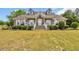 Charming two-story brick home with a welcoming front porch, well-manicured lawn, and lush landscaping at 1014 Academy Dr., Conway, SC 29526